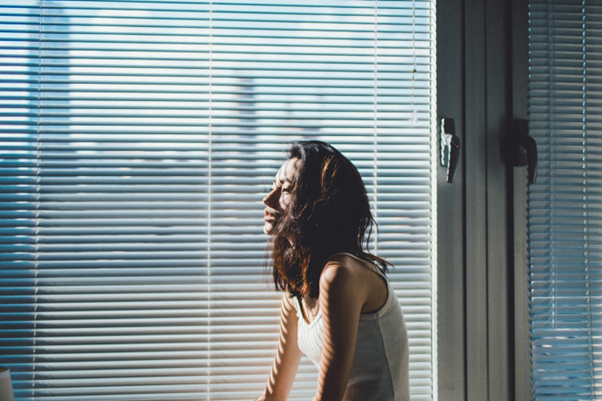 hot sun lady sitting next to window